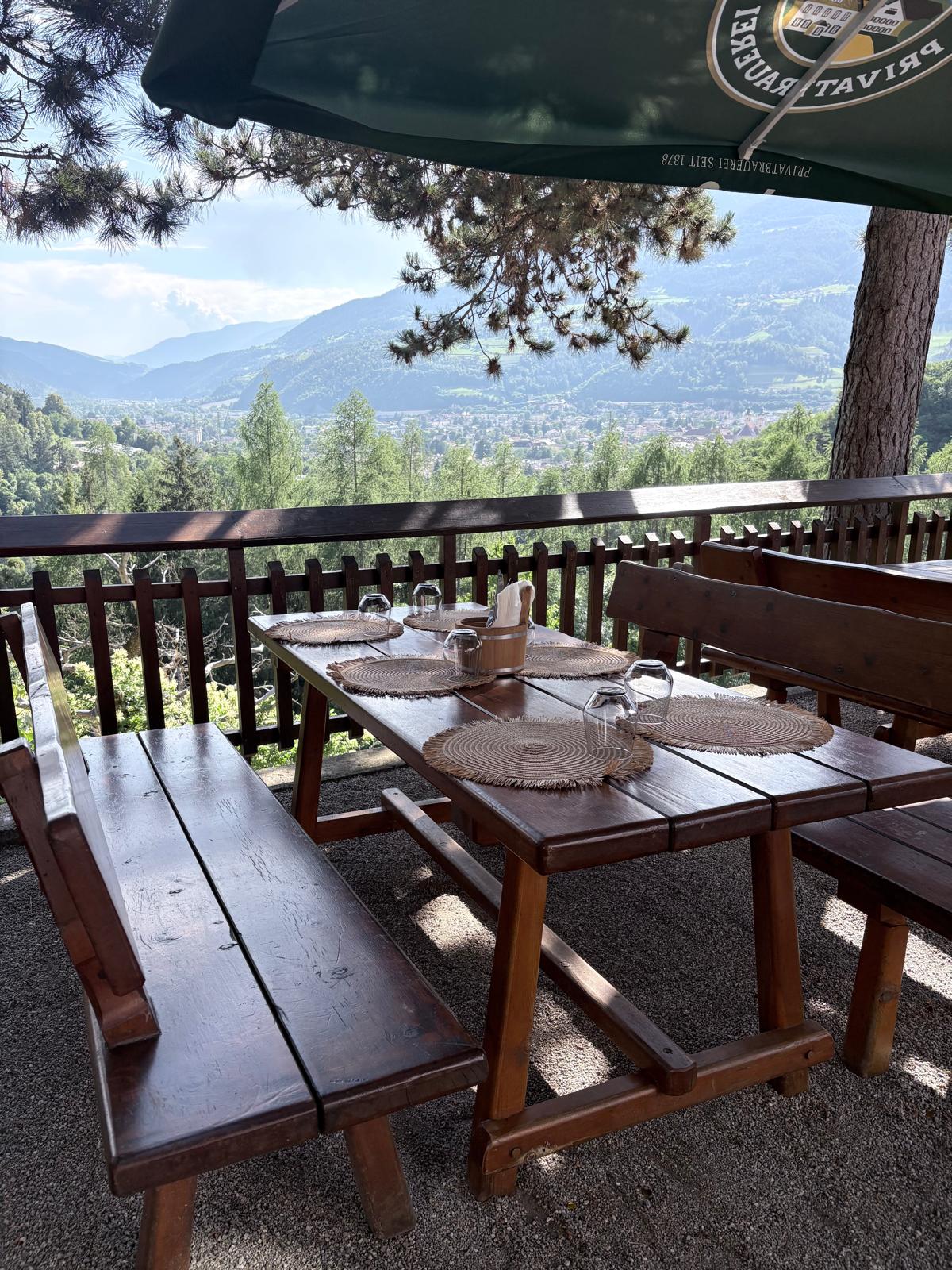 Beautiful wooden table setting on the outdoor terrace overlooking the mountains