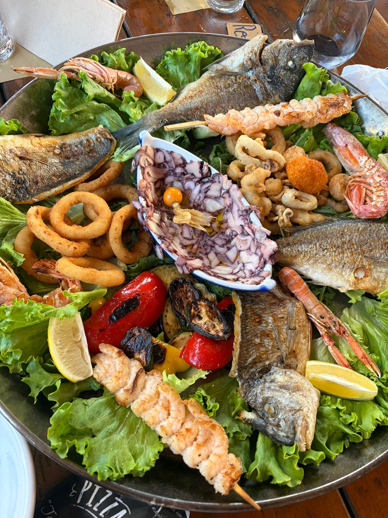 Massive mixed seafood platter with grilled fish, prawns, and calamari