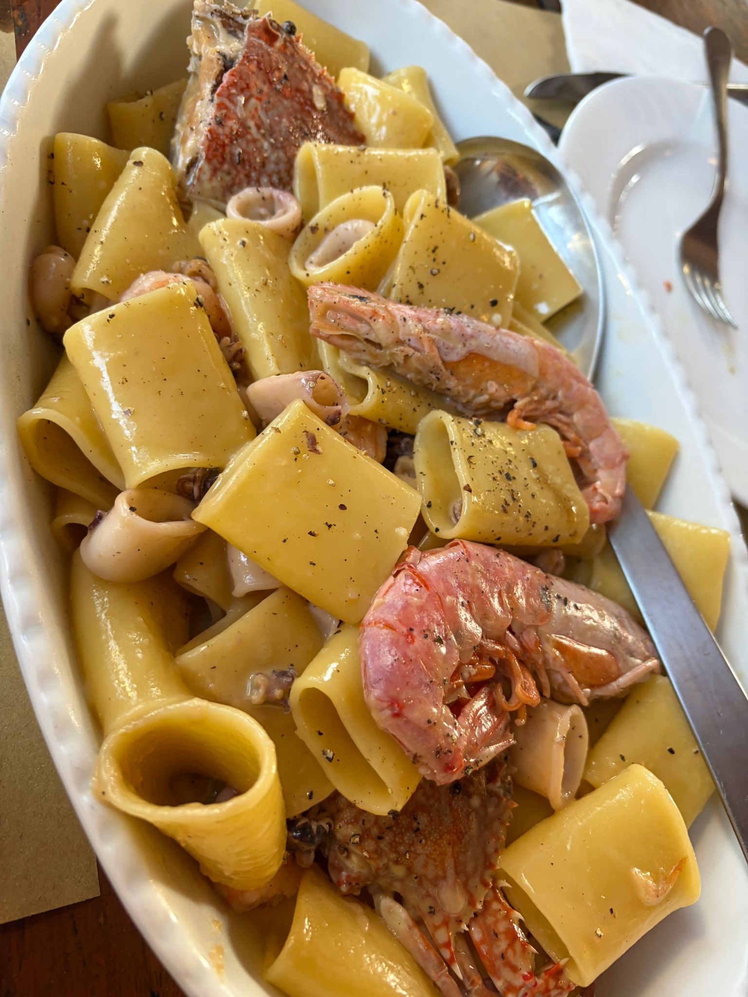 Beautifully plated seafood pasta with large prawns
